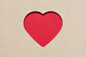 The red heart which is cut out from a cardboard