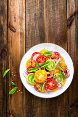 Tomato salad. Fresh vegetable salad with tomatoes, onion and basil
