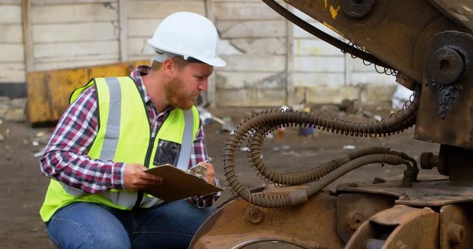 Male worker looking at machine 4k