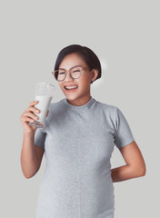 Asian girl smiles when she was drinking milk.Focus on face
