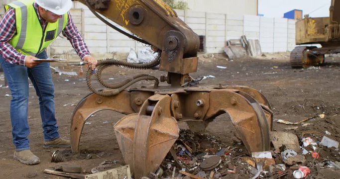 Male worker looking at machine 4k
