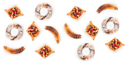 Top view of many delicious pastries isolated on white background. Flat lay, horizontal image