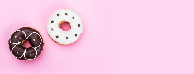 Tasty glazed donuts on color background. Top view of delicious dessert, horizontally