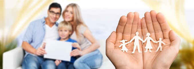 Fototapeta premium Hands with paper family, happy family concept