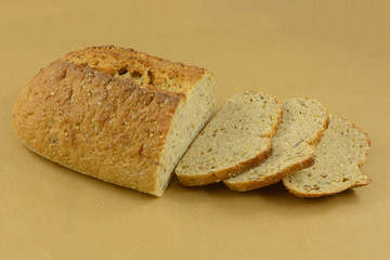Baked loaf of Focaccia bread with sesame seeds with some slices cut