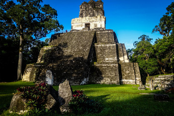 View looking up at the looming, 38m tall Templo II pyramid, standing in the main plaza of the...