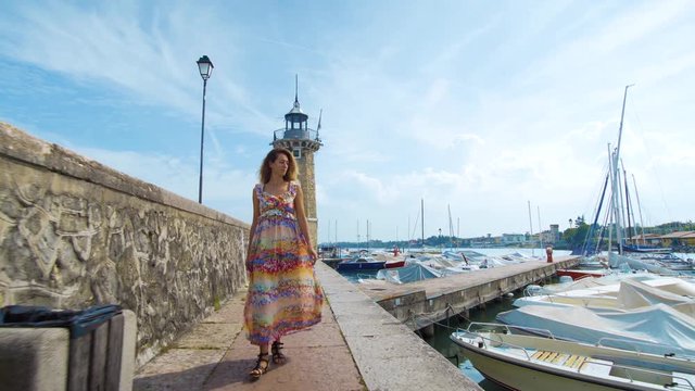 Beautiful girl goes to a lighthouse