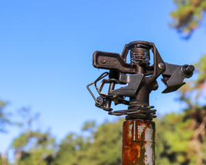 Sprinkler head against sky