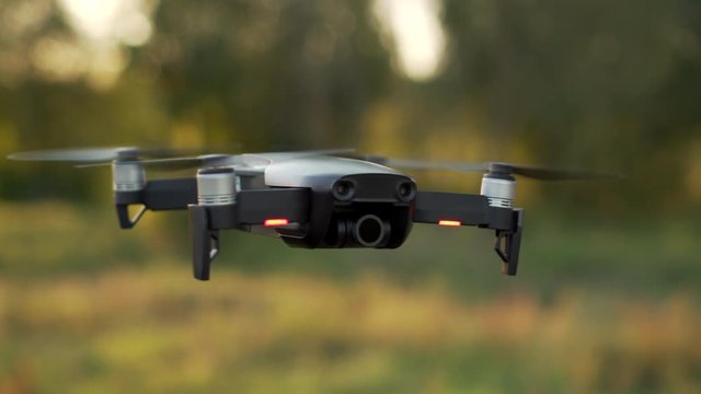 drone in air above ground examines terrain, close-up