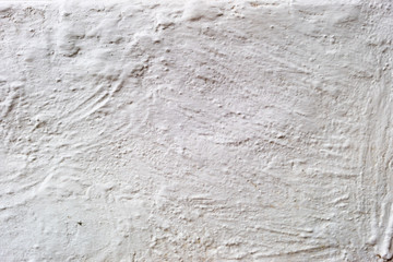 Background light gray, embossed plaster with stripes and scratches.