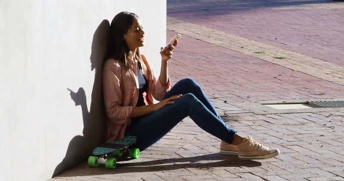 Woman talking on mobile phone during sunny day 4k