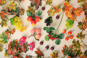 Different autumn fruits among the leaves, top view