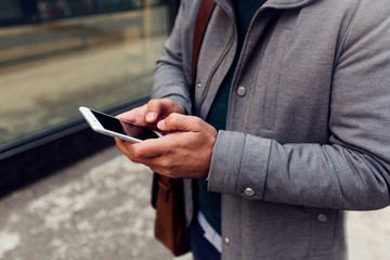Cropped shot of businessman using smartphone.Social media concept