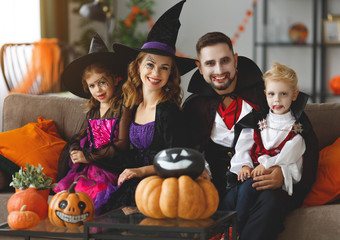 happy family mother father and children in costumes and makeup on  Halloween