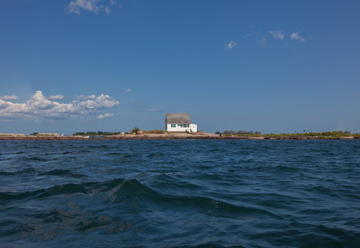 Landscape with house on coast seen from sea