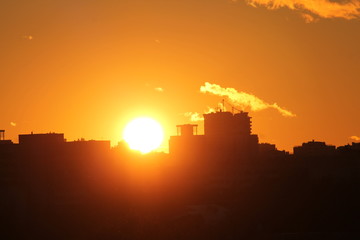 Cityscape with silhouette of city skyline against setting sun. Minsk, Belarus