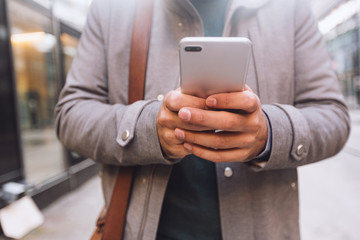 Cropped shot of businessman using smartphone.Social media concept