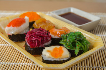 Sushi rolls served on a wooden plate