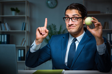 Young employee with tennis ball