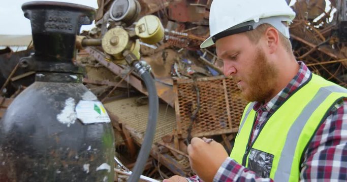 Male worker examining gas cylinder 4k