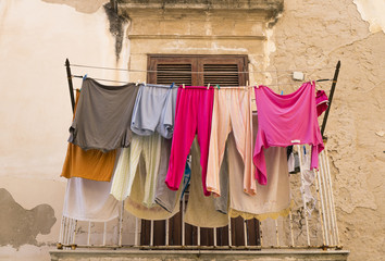 Balcony with colourful washing drying on Ortigia Island, Syracuse, Sicily