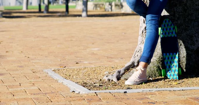 Woman standing in park on a sunny day 4k