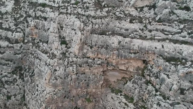 Backwards shot of a cliff in malta at blue groto