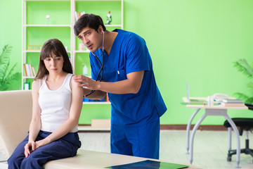 Fototapeta premium Female patient visiting male doctor in medical concept 