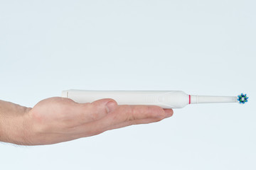Electrical toothbrush lay on hand