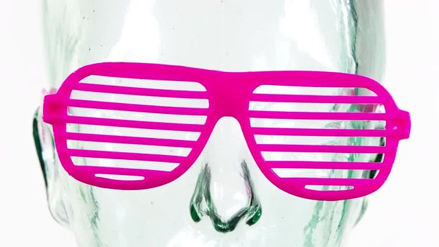 a clear glass mannequin head with amazing changing collection of sunglasses and shades