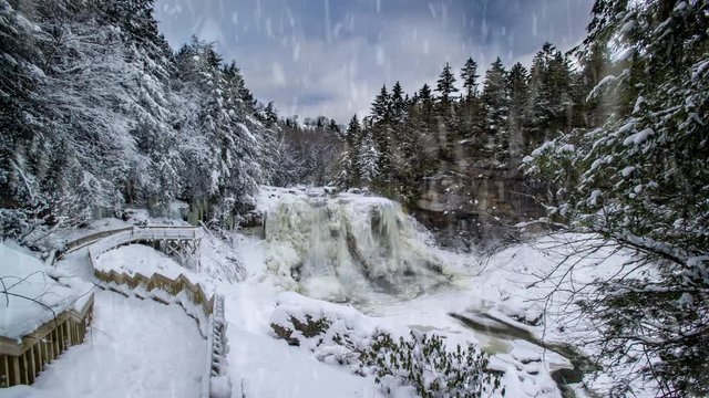 Cinemagraph of Blackwater Falls in winter with ice and snow while snowing heavily.