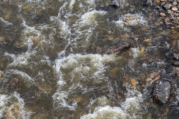 Water flows in streams with many granite rocks.