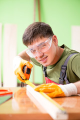 Young man carpenter working in workshop 