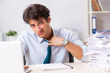 Overloaded busy employee with too much work and paperwork