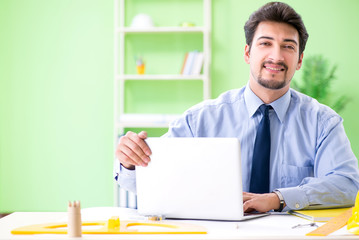 Young male architect working at the project