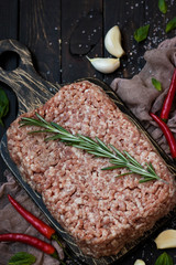 Raw meat with fresh herbs and pink Himalayan salt