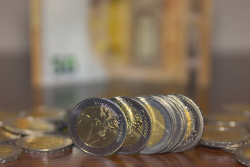 2 euro coins in front close up and 50 eur banknote background