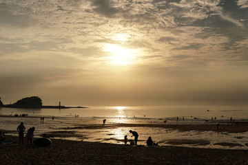 Mother and son on an evening beach 