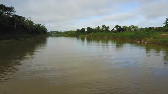 Aerial view of a single speed boat sailing on the Envira river in a Brazillian village Nova Morada
