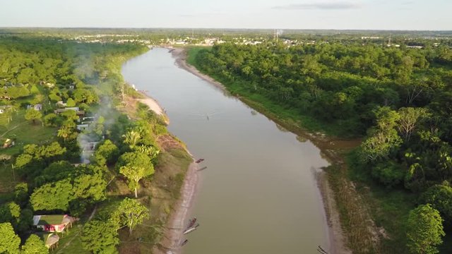 Drone aerial shot of a Brazillian village Nova Morada in the state of Acre, boats at the bank of the Envira river