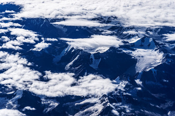 Fototapeta premium View of snow capped mountain range near Leh city and cloudy sky - Bird's eye view