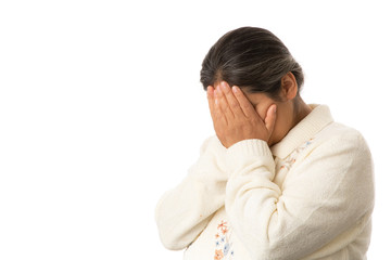 Hispanic Woman with Hands in Face Praying with Great Sadness Isolated on White Background