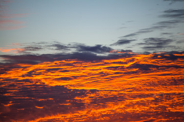 view of a bright orange sunset like a fire with burn clouds