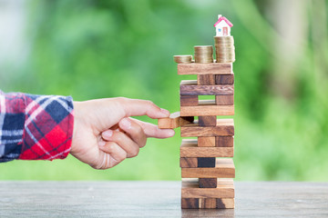 businessman   placing wooden block on a tower, Planning, risk and wealth strategy in business concept, . protection of investments and deposits. family, home.