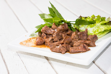Beef stir fry with green salad on white background, Thai Food stye