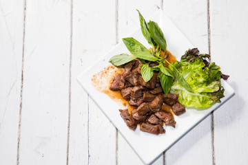 Beef stir fry with green salad on white background, Thai Food stye