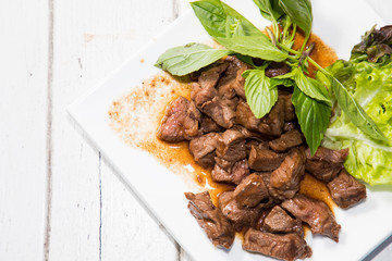 Beef stir fry with green salad on white background, Thai Food stye