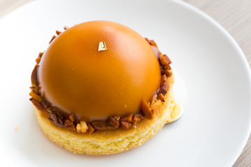 Dessert cake caramel and chocolate on white disk