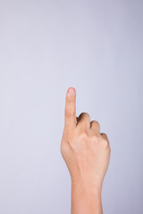 Hand with index finger on a white background