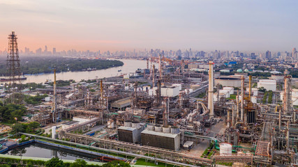 Fototapeta na wymiar Aerial view petrochemical industrial oil refinery at sunset with city background.